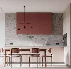 a modern kitchen with red cabinets and marble counter tops, along with bar stools