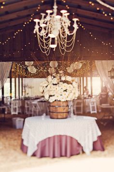 an image of a table with flowers and chandelier in the background on instagram