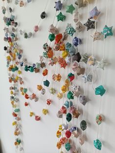 the wall is decorated with many different colored ornaments hanging from it's sides,