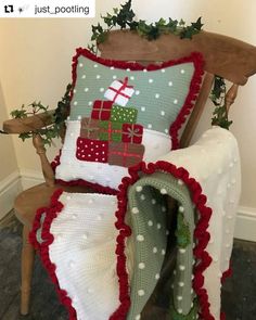 a chair with a christmas pillow on top of it next to a blanket and slippers