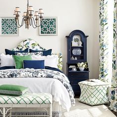 a bedroom with blue and green decor on the walls