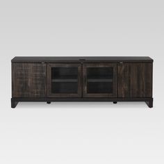 the sideboard is made out of wood and has two glass doors on each side