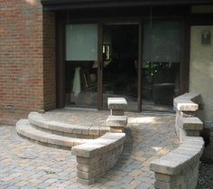 an outdoor patio with stone steps leading up to the door