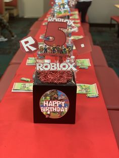 the table is set up for roblox's 6th birthday party with red decorations