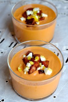 two small bowls filled with food on top of a table