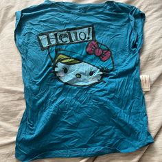 a hello kitty t - shirt is laying on a bed