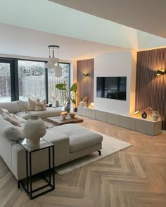 a living room with wood flooring and large windows