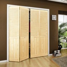 a living room with two wooden doors and a rug on the floor in front of it