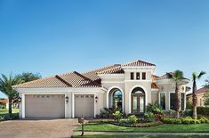 a large house with two garages and palm trees in the front yard on a sunny day