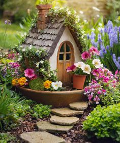 a garden with flowers and a small house