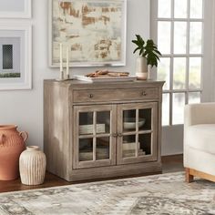 a white cabinet with glass doors in a living room