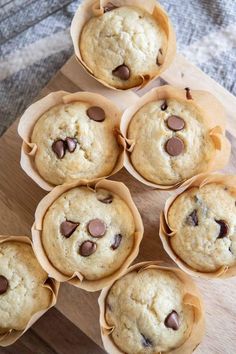 chocolate chip muffins in paper cups on a cutting board