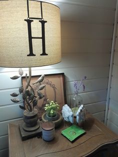 a lamp that is sitting on top of a table next to a potted plant