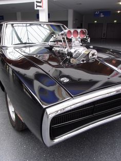 an old muscle car parked in a garage