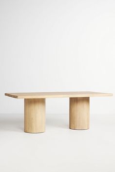 a wooden table sitting on top of a white floor