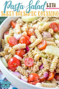 pasta salad with tomato, cucumber and onions in a white bowl on a colorful cloth