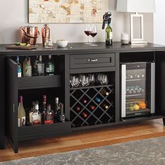 an entertainment center with wine bottles and glasses