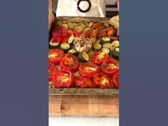 a person standing in front of a table filled with vegetables