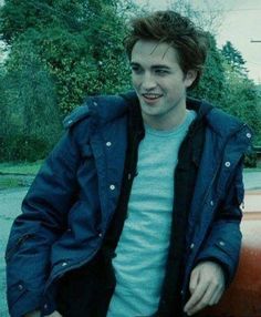 a young man sitting on the hood of a car