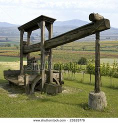 an old wooden structure in the middle of a field