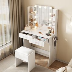 a white vanity table with lights on it and a stool in front of the mirror