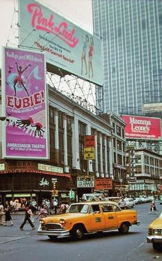 a busy city street filled with traffic and tall buildings