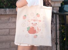 Hi! Thank you for stopping by Alyne and Co. ❤️ 🌟 WHAT YOU'LL RECEIVE - A Lightweight and Compact Tote Bag - Made from 100% Cotton  - Reinforced Handle Stitching  - Please note: Due to monitor differences, actual colors may vary slightly from what appears online. 🌟 SIZE: - ONLY AVAILABLE IN ONE SIZE  - Tote Size: 15.75 inch (Height) by 15.25 inch (Width) - Handle Length: 21.5 inches 🌟 SHIPPING INFO: - This Product is Made-To-Order for each one of our customers - Processing time: 1-3 business days - US delivery time: 2-7 business days. - International delivery time: 7-21 business days. - Printed, Packaged, And Shipped From the USA with love ❤️ 🌟 CARE INSTRUCTIONS: - Pretreat visible stains with stain remover - Mix warm water with laundry detergent and clean the bag with a terry washcloth Kawaii Cute Tote Bag, Cute Kawaii Tote Bag, Kawaii Tote Bag With Cute Design, Casual Bags With Cute Design For Gift, Casual Bags Suitable As Gifts, Cute Pink Canvas Bag, Cute Everyday Canvas Bag, Kawaii Tote Gift Bag, Kawaii Tote Bag For Gift