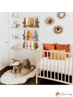 a baby's room with a crib, stuffed animal and wall decorations on the walls