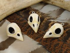 three pieces of animal skin with fake eyes on them