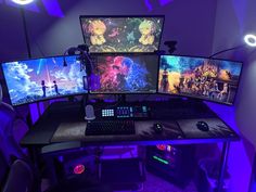 three computer monitors sitting on top of a desk in front of purple lights and chairs