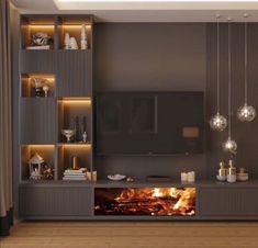 a living room with an entertainment center and fire in the fireplace, surrounded by hanging lights