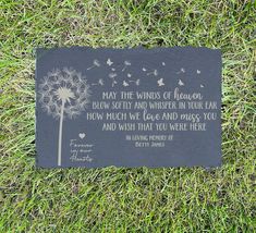 a plaque on the grass that says may the winds of heaven blow softly and whisper in your ear how much we love and miss you and wish that you were there