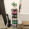 an assortment of dice sitting on top of a table next to a clock and plant