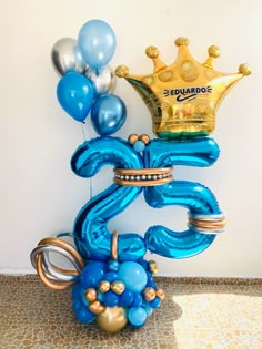 a balloon sculpture with a crown on top and balloons in the shape of an octopus