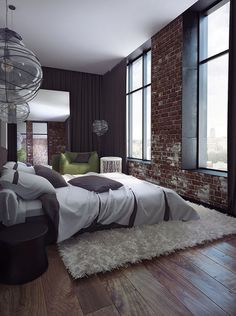 a bedroom with brick walls and large windows