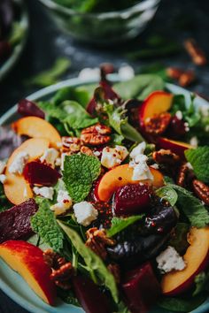 a salad with peaches, feta cheese and pecans