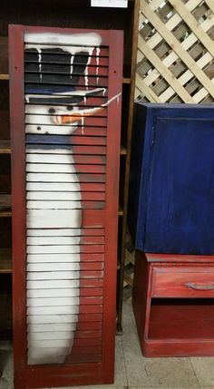 two old wooden shutters that have been painted to look like snowmen