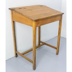 a small wooden table sitting on top of a white floor