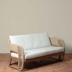 a white couch sitting on top of a wooden floor