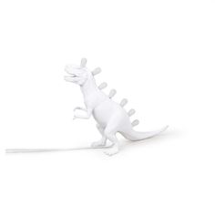 a white toy dinosaur with its mouth open and tongue out, on a white background