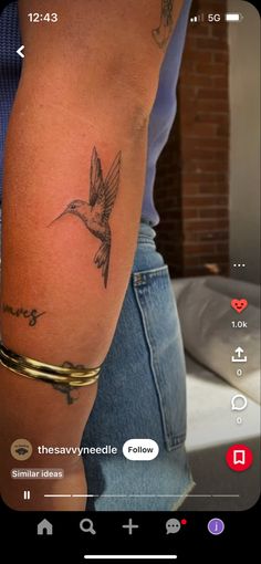 a person with a bird tattoo on their arm