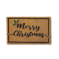 a merry christmas door mat with holly on it