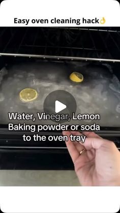 someone is removing lemons from an oven with water, vinegar, lemon baking powder or soda to the oven tray