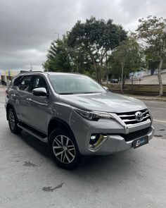 a silver toyota fortune is parked in the parking lot