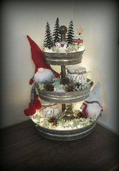 a three tiered tray with christmas decorations on it