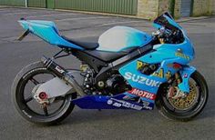 a blue motorcycle parked in front of a building