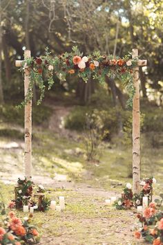 an outdoor ceremony with candles and flowers