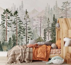 a bedroom with a forest mural on the wall next to a bed and pillows in front of it