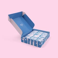 a blue box with the word coffee printed on it is open to reveal its inside