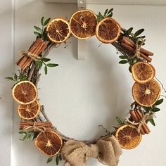 an orange wreath with cinnamons and spices